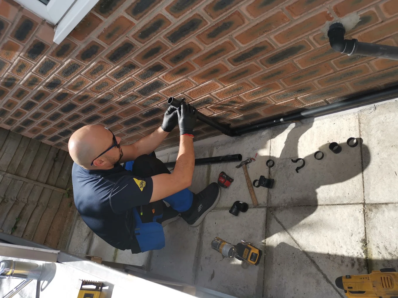 Gas Safe registered plumber fitting external soil and waste pipework to a Merseyside home