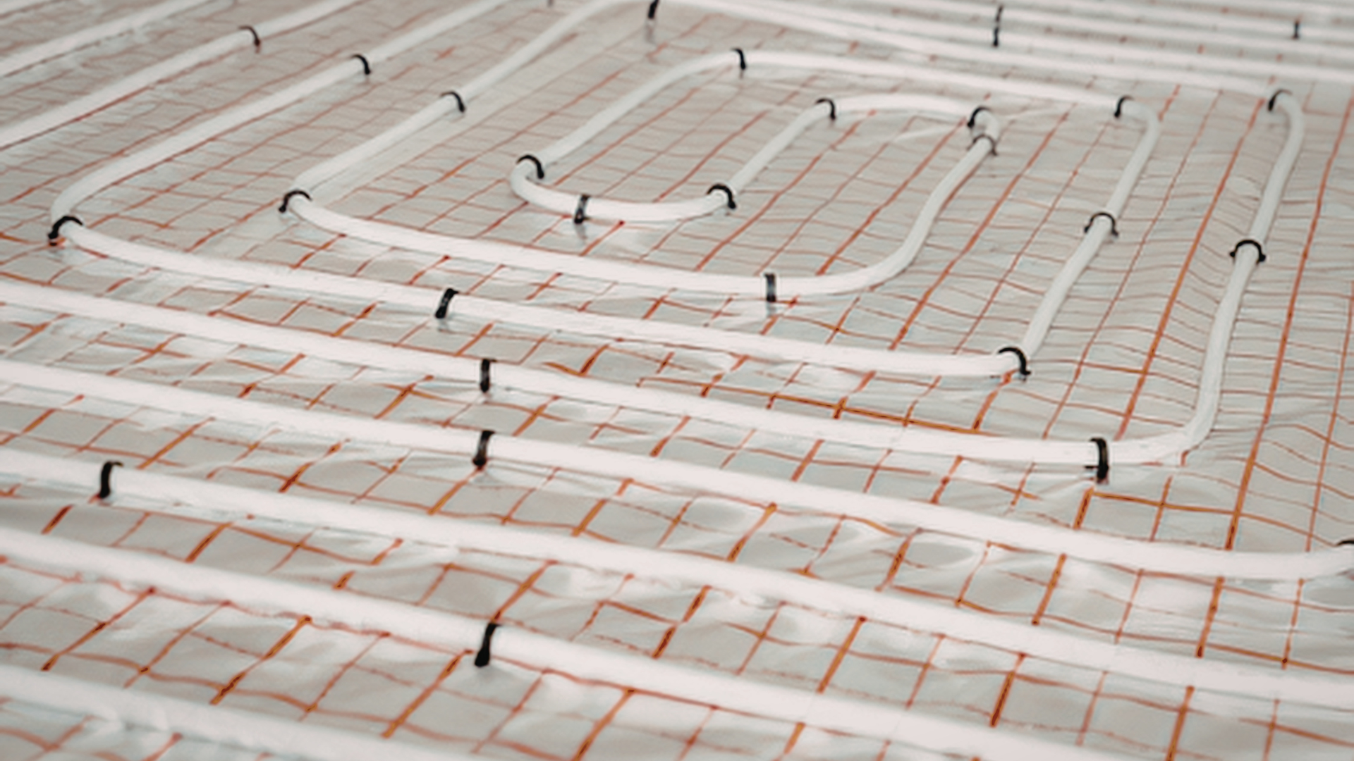 Underfloor heating pipework laid out on insulation before screeding