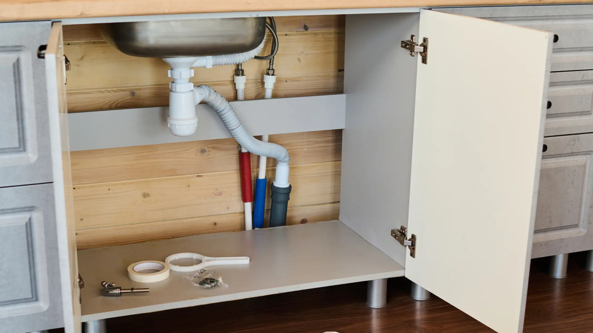 Leaking waste pipework under a kitchen sink repaired on an emergency visit