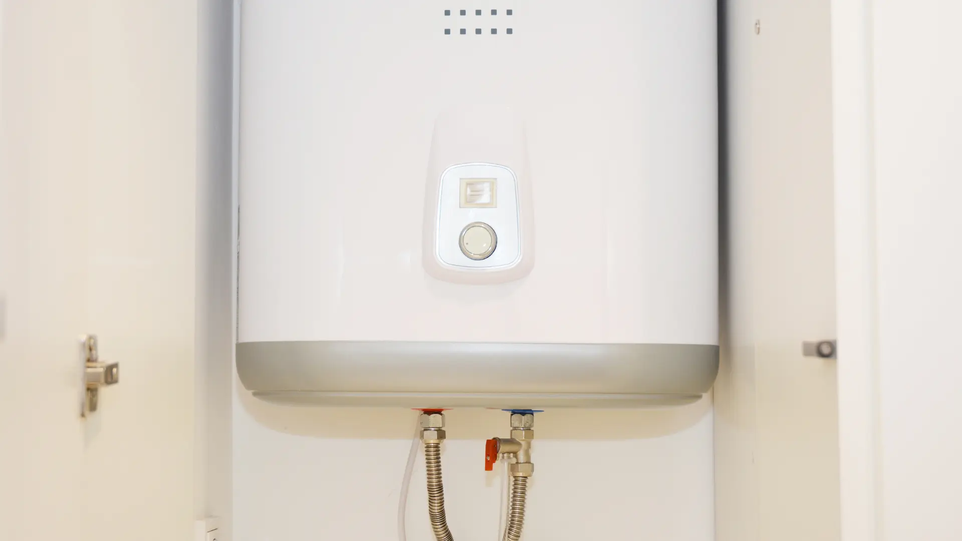 New combi boiler installation with tidy pipework inside a kitchen cupboard
