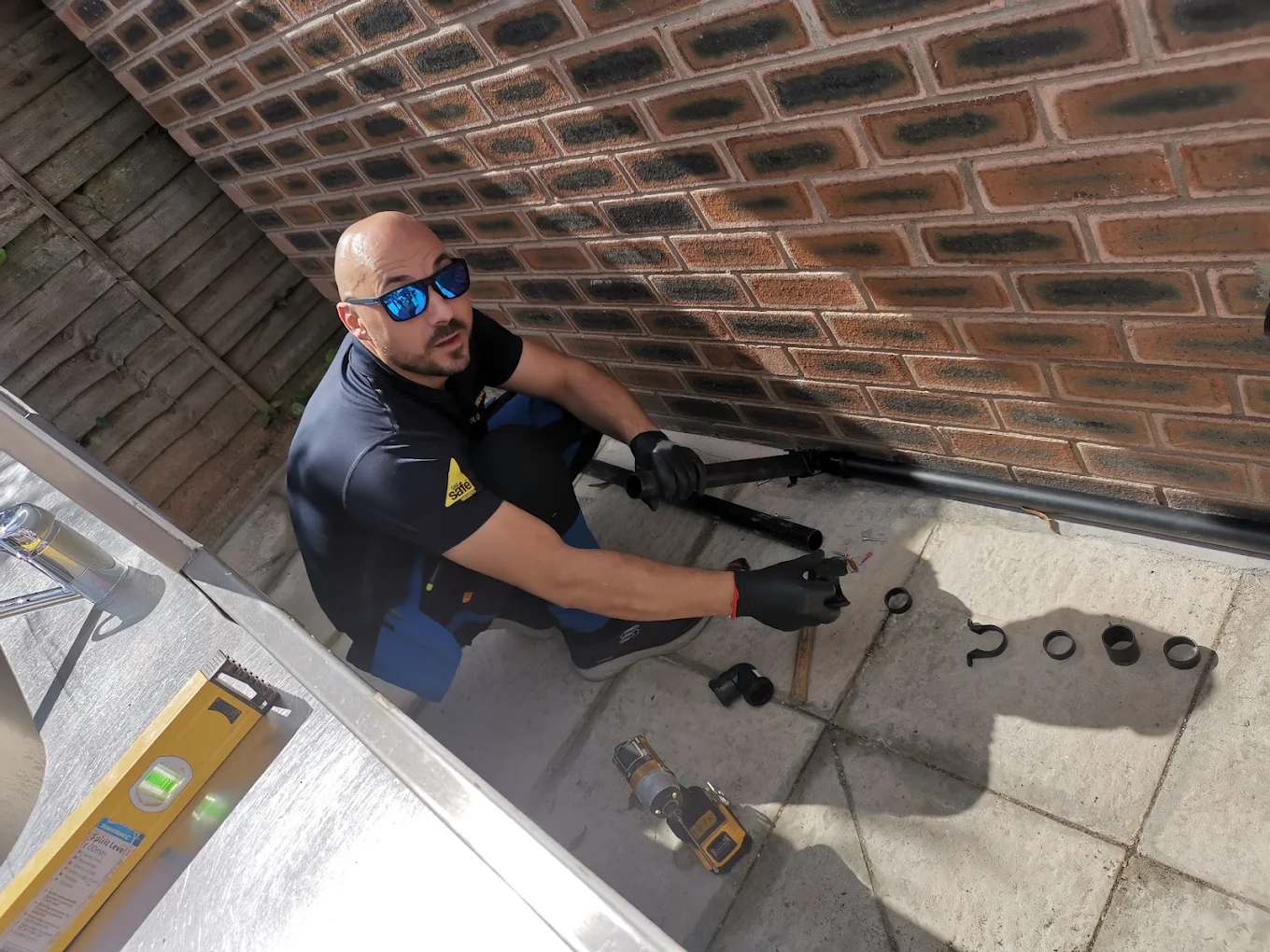 Ivan Kondov, Gas Safe registered owner of BLU Plumbing, fitting external pipework at a Liverpool property